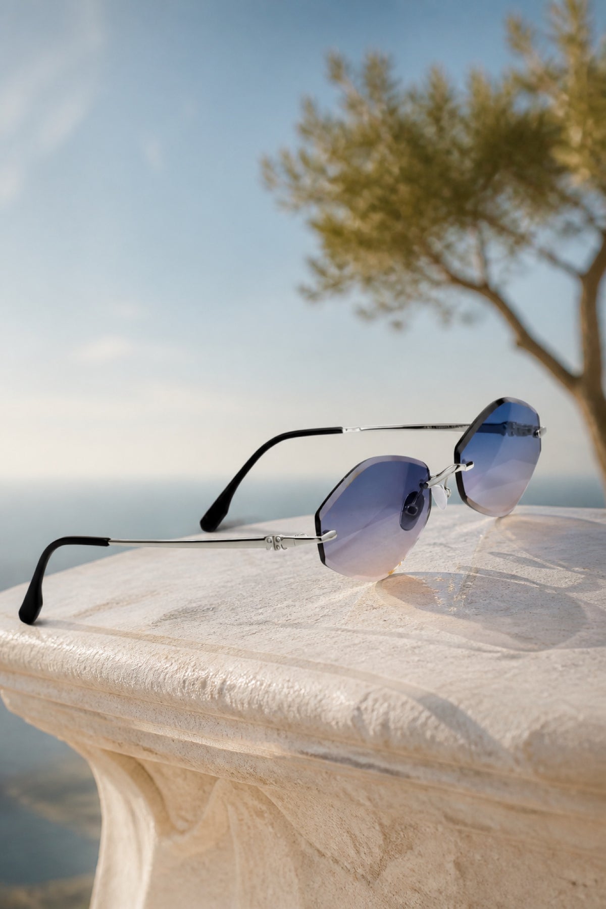 JYNX DAWN sunglasses outdoors with blue gradient lenses and Mediterranean tree — Red Raven